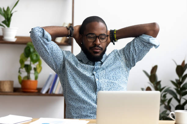 istock Black confident worker finish work sitting resting at office desk 1091526894
