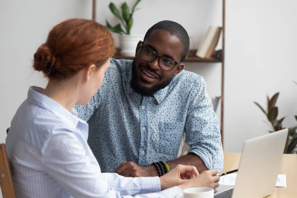 istock Diverse coworkers talking having pleasant conversation in office room 1091526954
