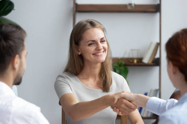 istock Attractive newcomer shaking hands getting acquainted with company staff 1091527082