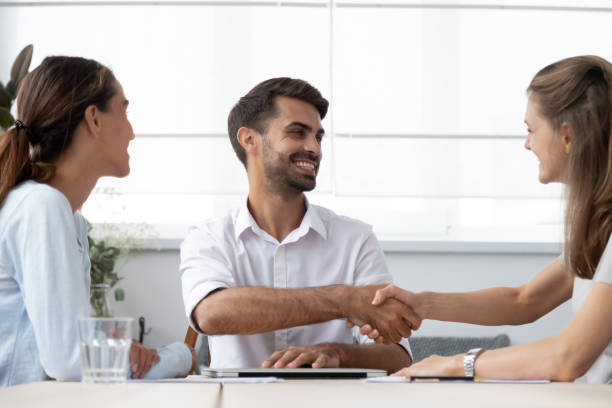 istock Male boss greeting female client before starting negotiations 1091527116