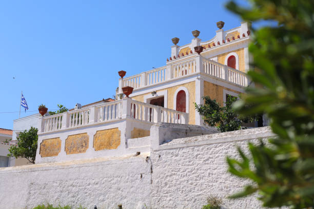 Spetses, Greece - August 15, 2018: Old traditional holiday villa on promenade at Spetses island, Saronic Gulf, Peloponnese, Greece