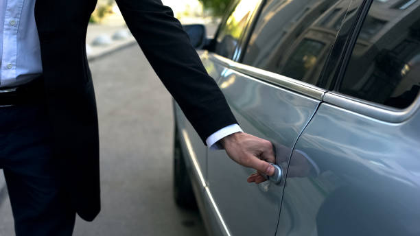 autista che apre porta auto a giovane oligarchia rispettabile, autista professionista - automobile personale foto e immagini stock