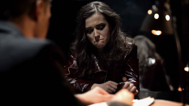 istock Detective interrogating crying lady, trying to get signed confession, punishment 1091530644