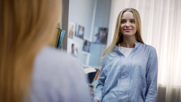 istock Smiling teen looking in mirror reflection, admiring herself, ready for new day 1091532484