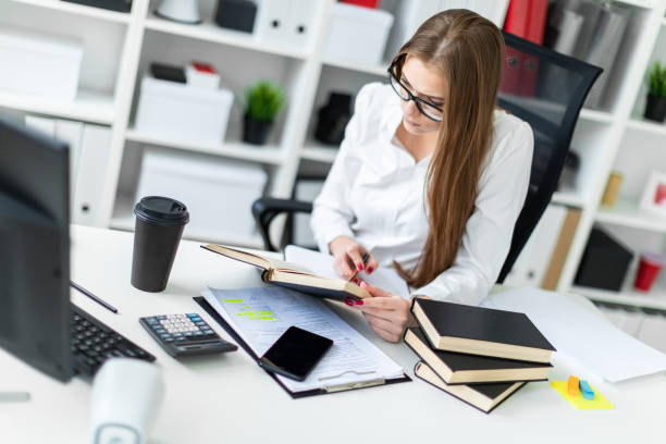 istock A young girl working in the office with books and documents. 1091534090