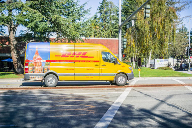 dhl van driving on the street - driving delivery van global business dhl imagens e fotografias de stock