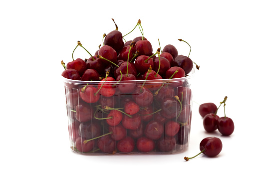 close-up of ripe cherries in a plastic container