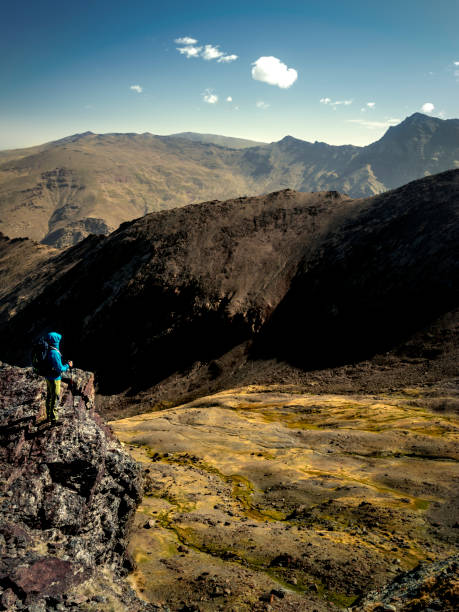 istock Anonymous hiker admiring view of mountains 1091550628