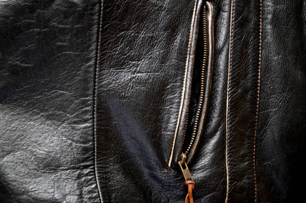 unzipped side pocket of leather motorcycle jacket Detail of old leather motorcycle jacket focusing on unzipped side pocket leather pocket clothing hide stock pictures, royalty-free photos & images