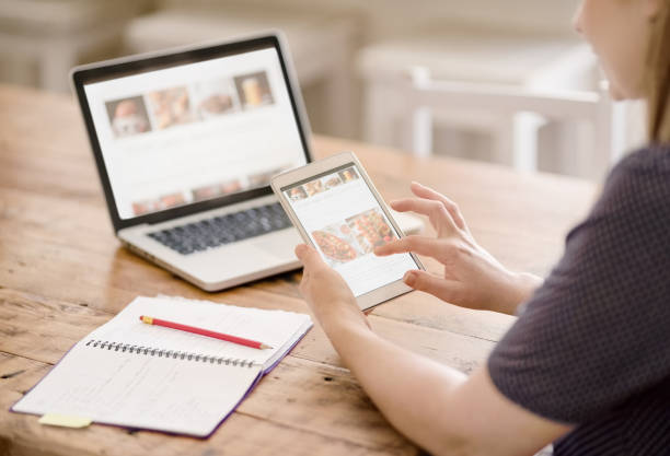 Woman viewing her website on a tablet and laptop