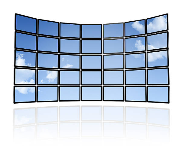 Wall of flat TV screens displaying a blue sky