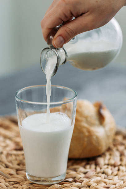 istock Bread and milk being put into the glass 1091573870
