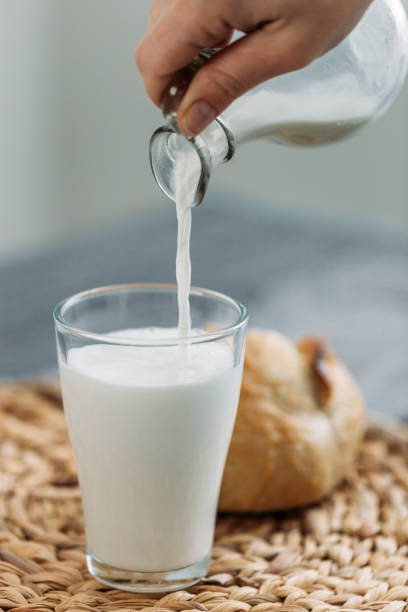 istock Bread and milk being put into the glass 1091573882