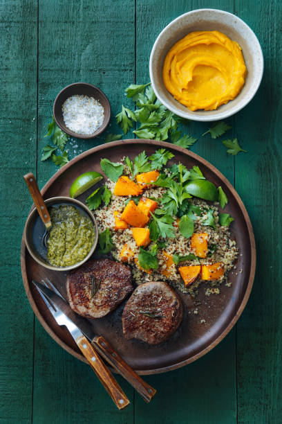 istock Filet mignon with chimichurri and quinoa salad with caramelised and mashed pumpkin 1091581200