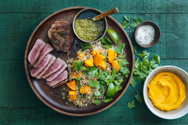 istock Filet mignon with chimichurri and quinoa salad with caramelised and mashed pumpkin 1091583312