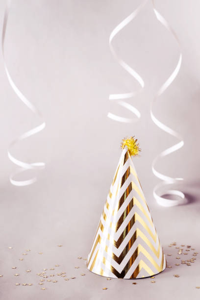 istock Party gray concept with golden striped cone hat 1091583658