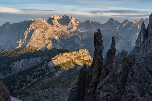 View from the pass Forcella della Neve (2,471 m) of the the Cadini group to the Marmarole range in the background at sunset (with the mountain Cimon del Froppa 2,932 m). It is located in the European Alps, Italy, Dolomites, Province of Belluno.