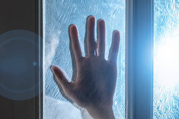istock horror scene of hand placed on door window at night time b 1091592326