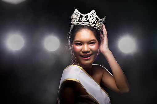 Concept every Girl Dream to Miss beauty Universe contest. Rural unique Bone Jawline Woman warships wear Diamond Silver Crown as Final want in Life, studio lighting with back light flare silhouette