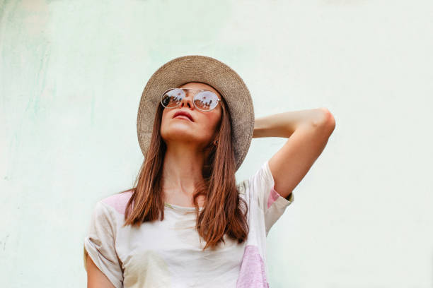 istock Woman in hat and sunglasses looking up 1091592982