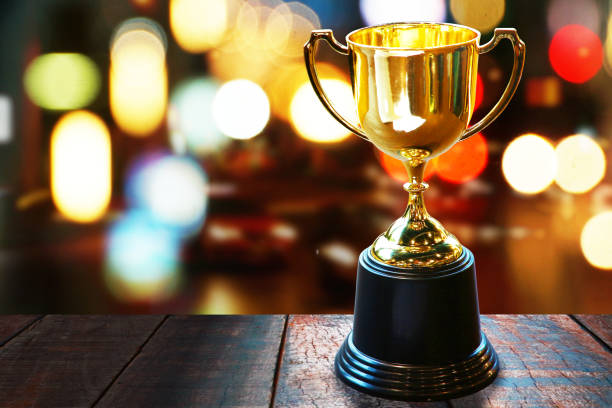 istock Trophy on wood table with abstract bokeh background 1091596964