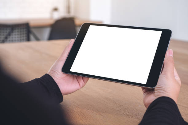 istock hands holding and looking at black tablet pc with blank white screen 1091601428