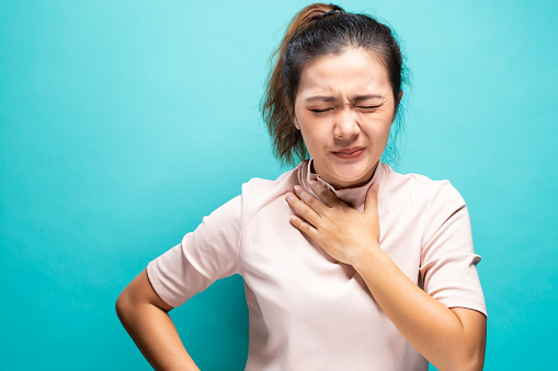 Woman feeling sick with sore throat