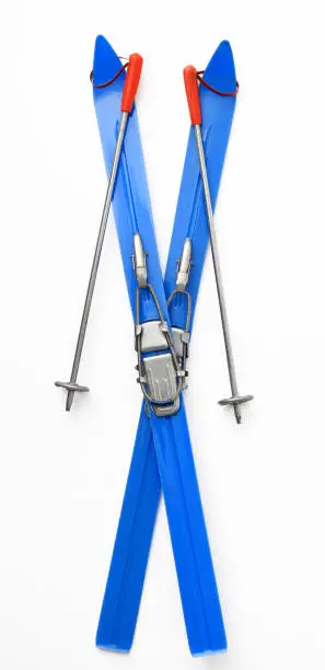 Photo of Isolated shot of cross shape vintage blue toy Skis & Poles on white background.