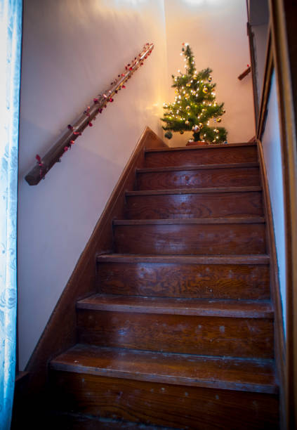 istock A Christmas tree up a old wooden staircase 1091609736