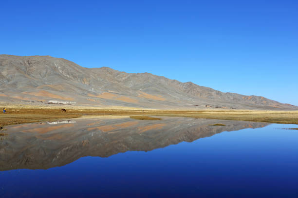 Reflection of lake after beautiful mountain with blue sky of Western Mongolia. Natural background