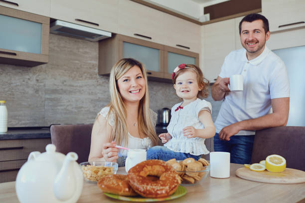 istock A happy family in the kitchen while sitting at a table. 1091614254