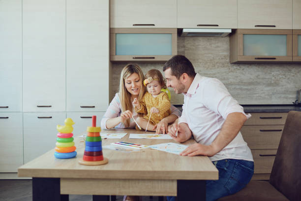istock Mother, father and child draw together at the table. 1091614292