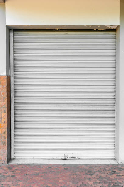 istock Old grunge weathered and dirty sky blue metal roller shutter door. 1091617832