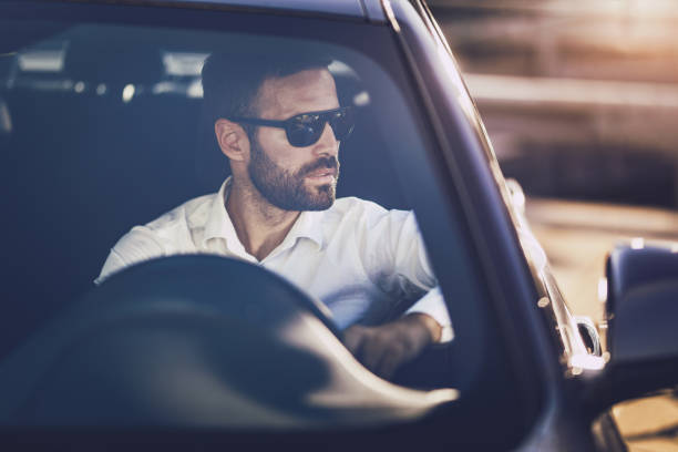 istock Businessman with sunglasses driving a car to work. 1091618538