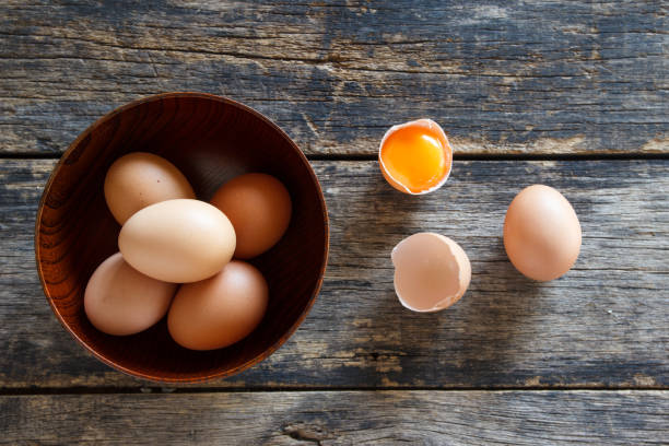 istock eggs in a wooden bowl on old wooden table top view 1091618674