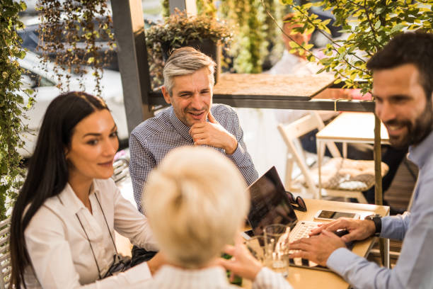 istock Group of happy business people communicating while working in a cafe. 1091618706