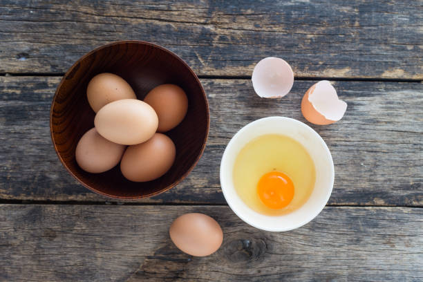 istock eggs in a wooden bowl on old wooden table top view 1091618912