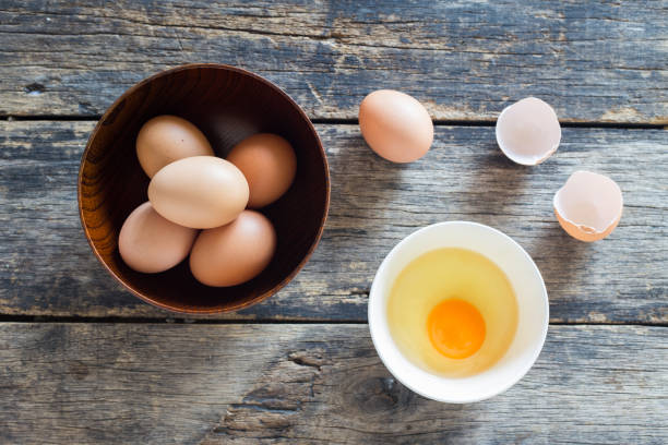 istock eggs in a wooden bowl on old wooden table top view 1091619732