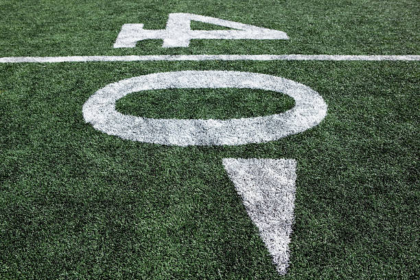 istock Football stadium 40 yard line artificial grass and markings 109162270