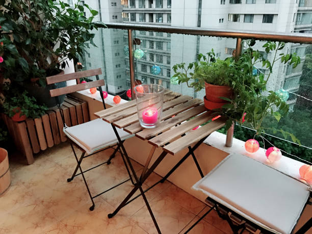 Lovely summer decoration for a terrace Decoration for terrace with plants, candle and furniture garden lights candle stock pictures, royalty-free photos & images
