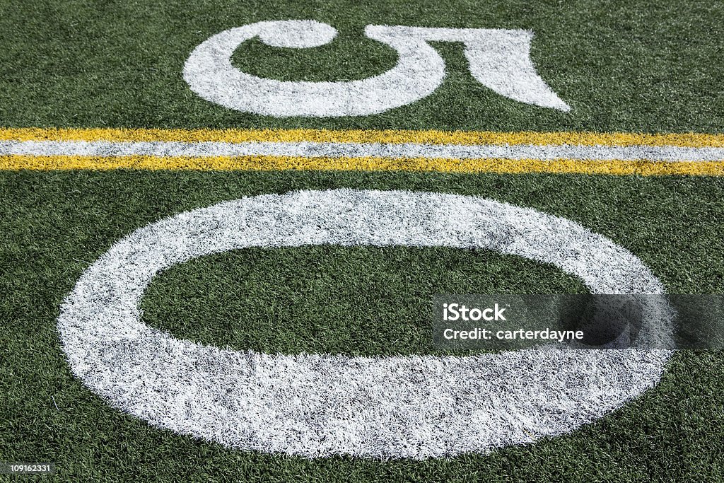 Football stadium 50 yard line artificial grass and markings Football field stadium artificial grass or astroturf, lines and numbers series.  50 Yard Line.  Fifty Yard Line.  Check out my  American Football Field Stock Photo