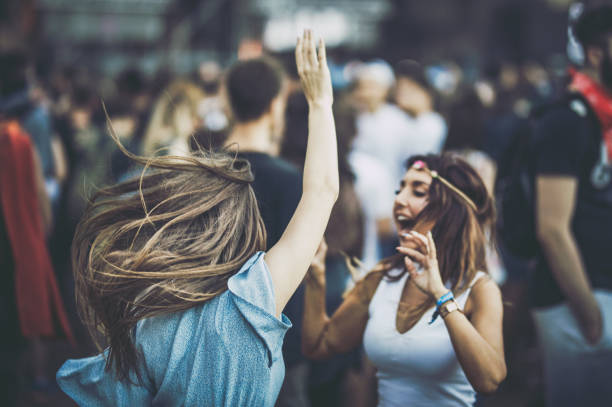 istock Young female friends having fun while dancing on a music concert. 1091624866