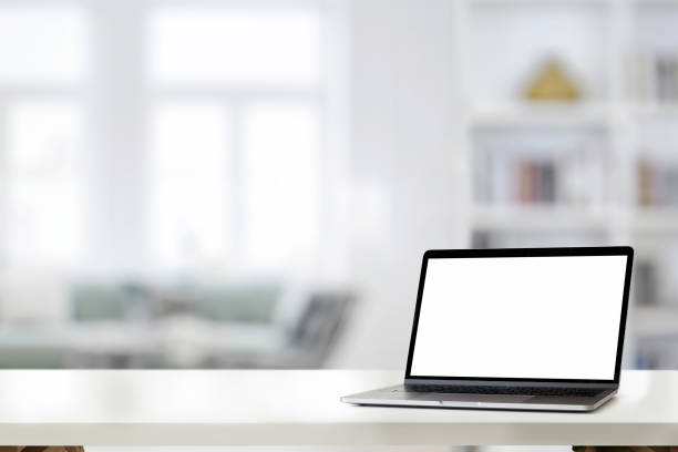 istock Mockup laptop on white desk at home 1091625378