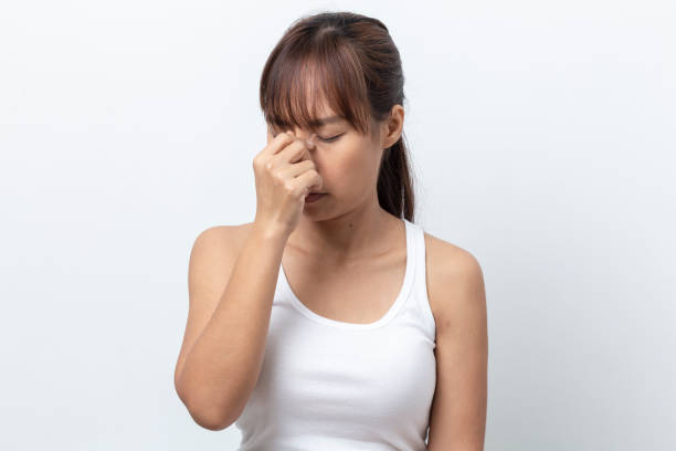 istock asian young  woman suffering from  headache on white background 1091625472