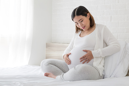 Asian pregnant women happy during pregnancy in the bedroom, Happiness and feel joyful as emotional well affect to baby neurological and psychological development