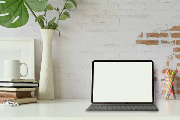 istock Front view of the tablet with Smart Keyboard on loft workspace table. 1091626960