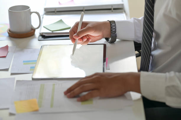 istock Business man writing on tablet on desk workplace. Blank copy space screen for your advertising graphic display 1091627062