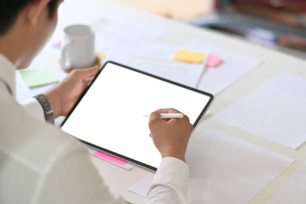 istock Business man writing on tablet on desk workplace. Blank copy space screen for your advertising graphic display 1091627068