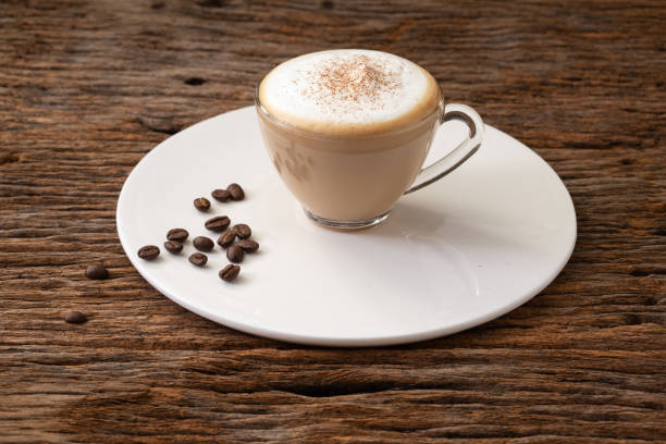 istock cappuccino coffee clear cup on wood background  for cafe coffee shop menu 1091630804