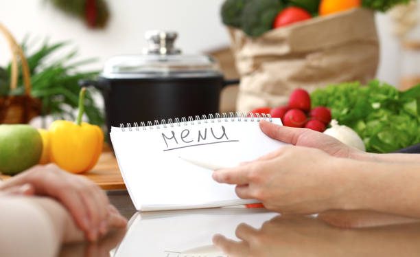 istock Closeup of human hands discussing something while cooking in kitchen. Women talking about menu. Family dinner, friendship and lifestyle concept. 1091633454